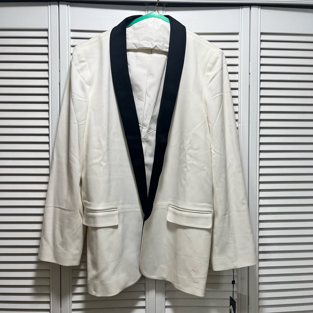 Off white tuxedo style jacket with black satin collar. Never been worn.